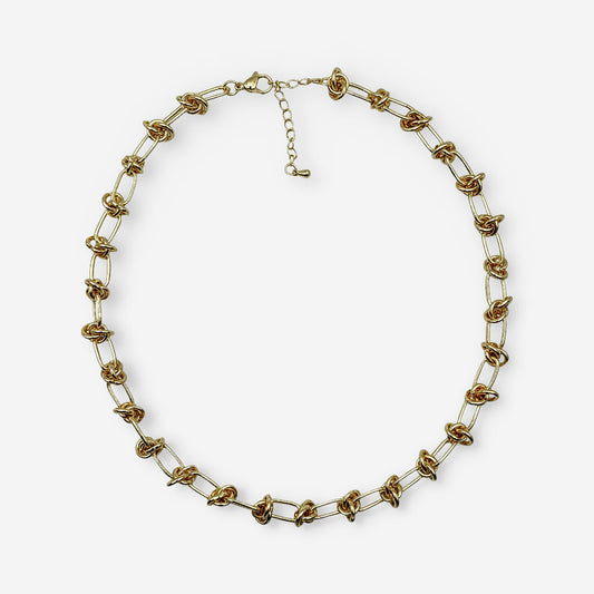 Collar dorado para mujer elaborado en bronce con baño de oro de 18K y diseño de eslabones ovalados con detalles de nudo.