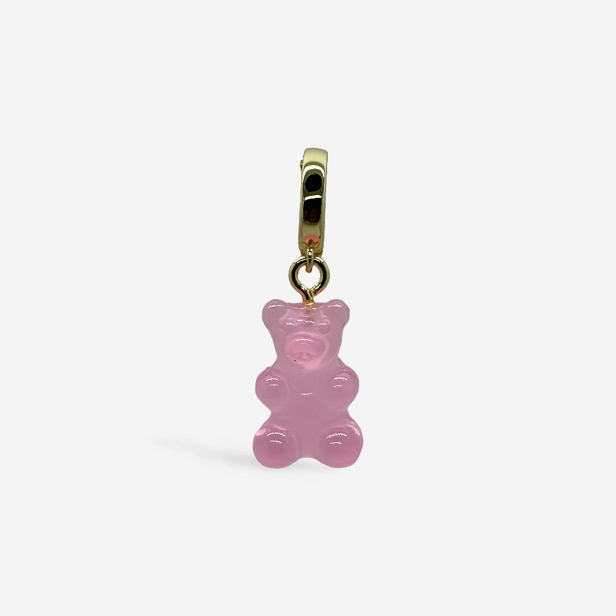 Dije osito de goma rosa con broche dorado, sobre fondo blanco.