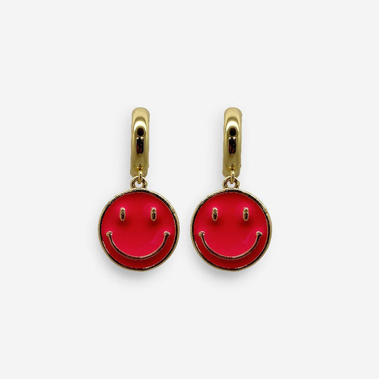 Aretes dorados con dije smiley fucsia