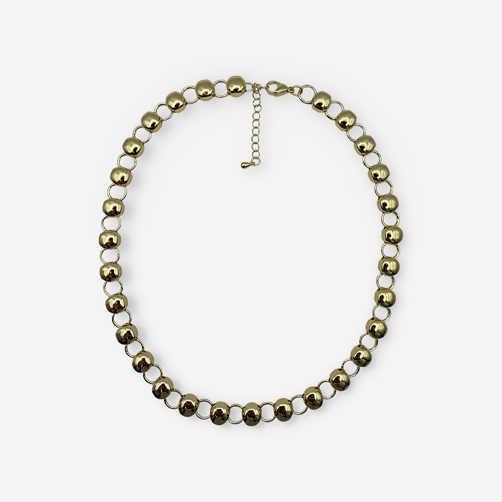 Collar dorado para mujer elaborado en bronce con baño de oro de 18K y diseño de esferas metálicas de 9 mm.