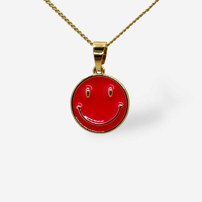 detalle dije de carita feliz fucsia con cadena dorada